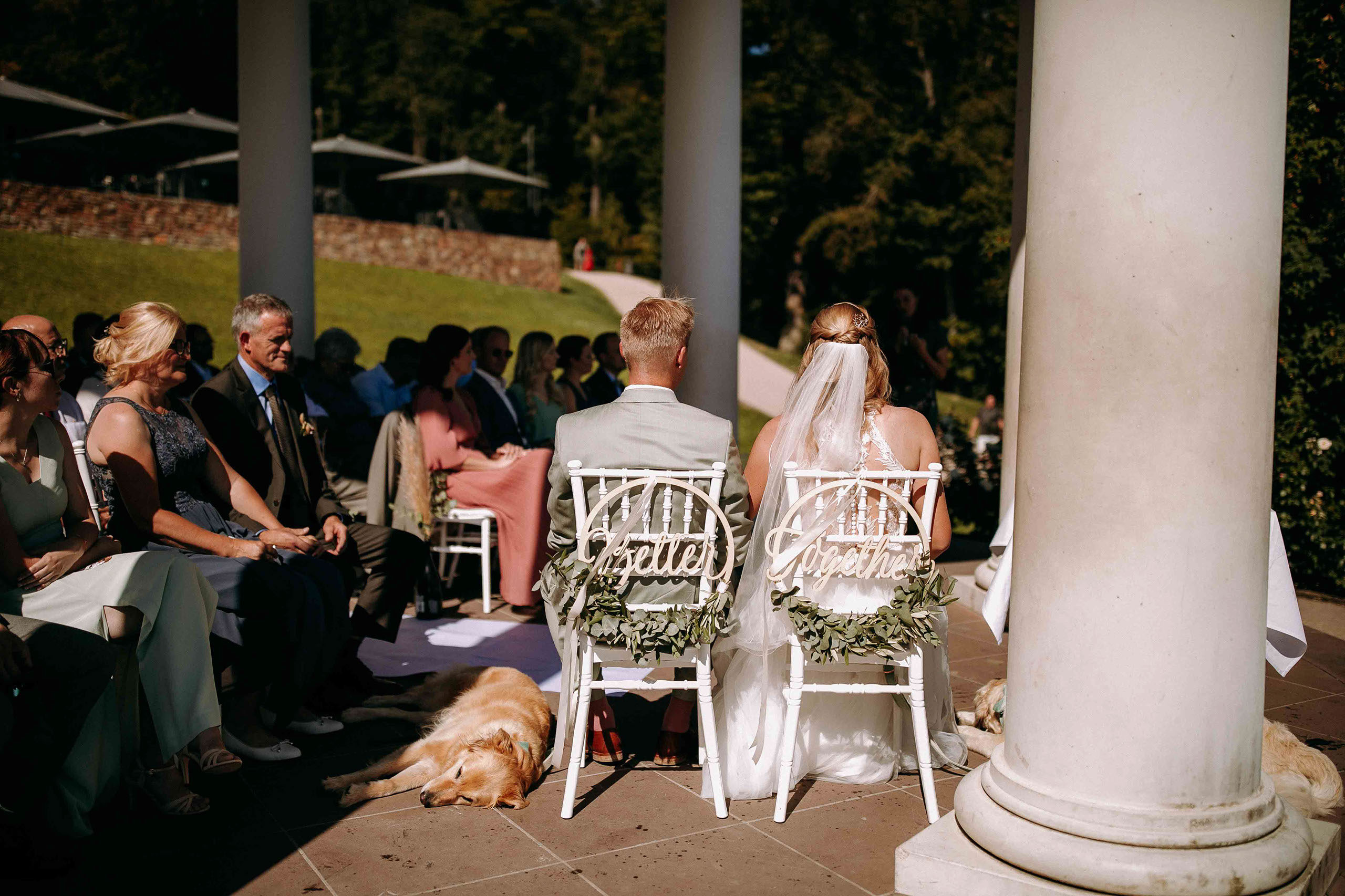 Persönliche Note: Das Brautpaar sitzt unter dem Tempel mit ihrem Hund während der Zeremonie.