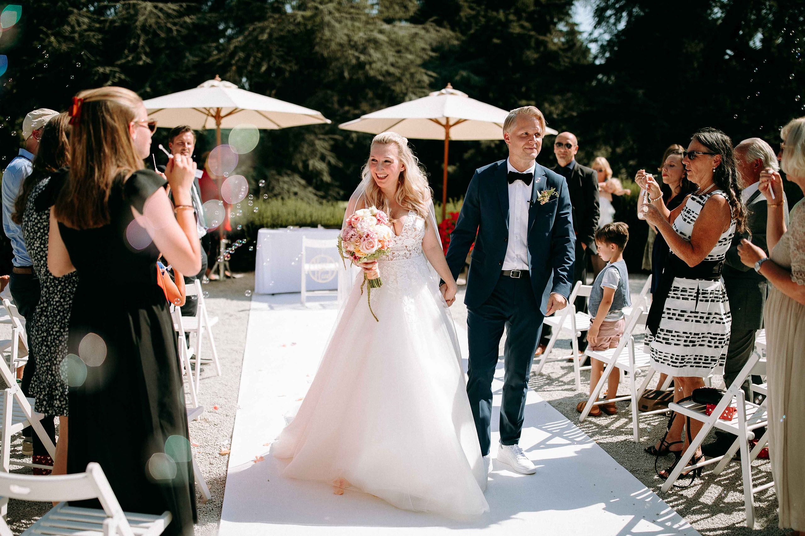 Hochzeitsauszug mit Seifenblasen vor dem Schlosshotel Kronberg – perfekte Szene für Hochzeitsfotografie.